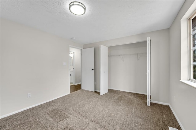 3414 Dearwood Dr SW, Lilburn, GA 30047 - unfurnished bedroom featuring carpet floors, a closet, a textured ceiling, and baseboards
