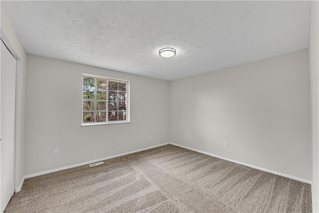 3414 Dearwood Dr SW, Lilburn, GA 30047 - unfurnished bedroom with carpet floors, a textured ceiling, baseboards, and a closet