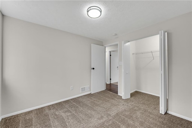 3414 Dearwood Dr SW, Lilburn, GA 30047 - unfurnished bedroom with carpet, a closet, a textured ceiling, and baseboards