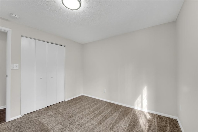 3414 Dearwood Dr SW, Lilburn, GA 30047 - unfurnished bedroom featuring carpet floors, baseboards, a closet, and a textured ceiling