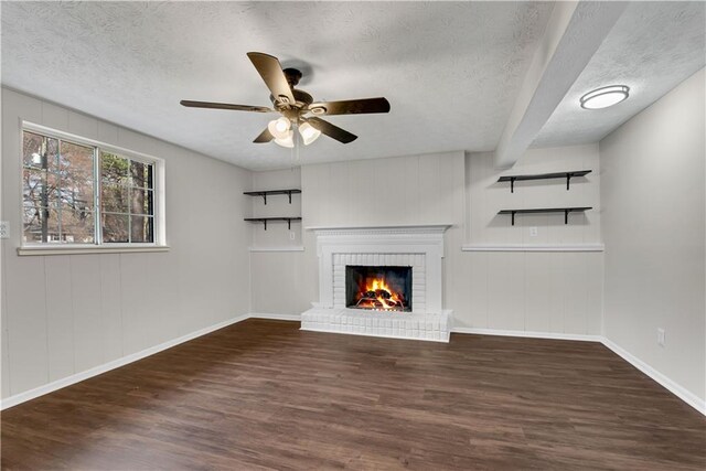 3414 Dearwood Dr SW, Lilburn, GA 30047 - unfurnished living room with wood finished floors, a textured ceiling, a ceiling fan, a fireplace, and baseboards