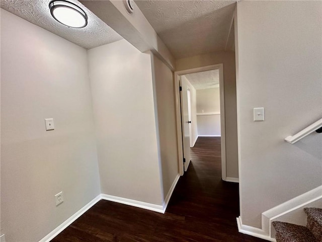 3414 Dearwood Dr SW, Lilburn, GA 30047 - corridor featuring wood finished floors, baseboards, and a textured ceiling