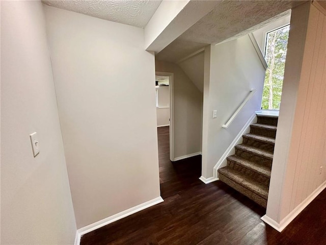 3414 Dearwood Dr SW, Lilburn, GA 30047 - stairway with wood finished floors, baseboards, and a textured ceiling