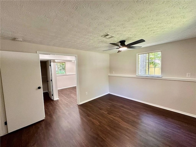 3414 Dearwood Dr SW, Lilburn, GA 30047 - empty room featuring wood finished floors, a textured ceiling, baseboards, plenty of natural light, and ceiling fan