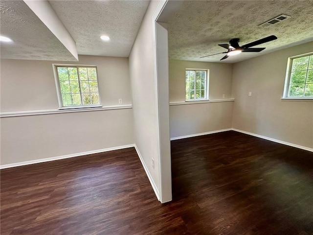 3414 Dearwood Dr SW, Lilburn, GA 30047 - spare room featuring a textured ceiling, baseboards, wood finished floors, healthy amount of natural light, and ceiling fan