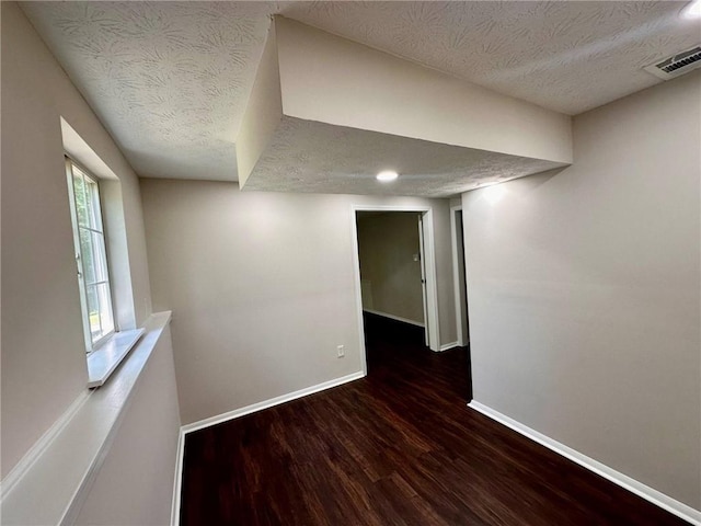 3414 Dearwood Dr SW, Lilburn, GA 30047 - empty room with a textured ceiling, baseboards, and wood finished floors