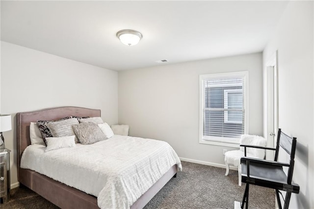 bedroom with dark colored carpet