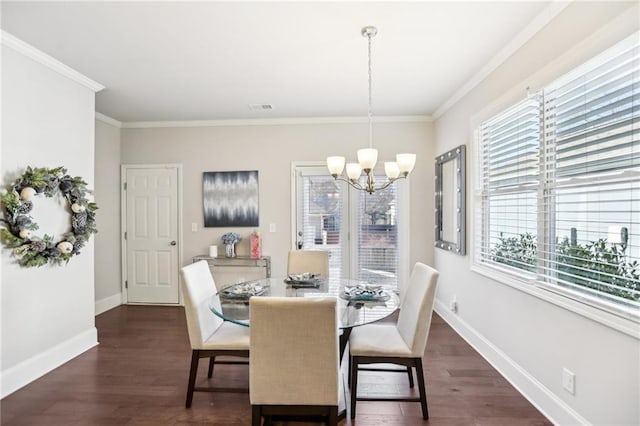 dining room with dark hardwood / wood-style flooring, an inviting chandelier, ornamental molding, and a wealth of natural light