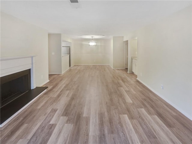 unfurnished living room with light wood-type flooring