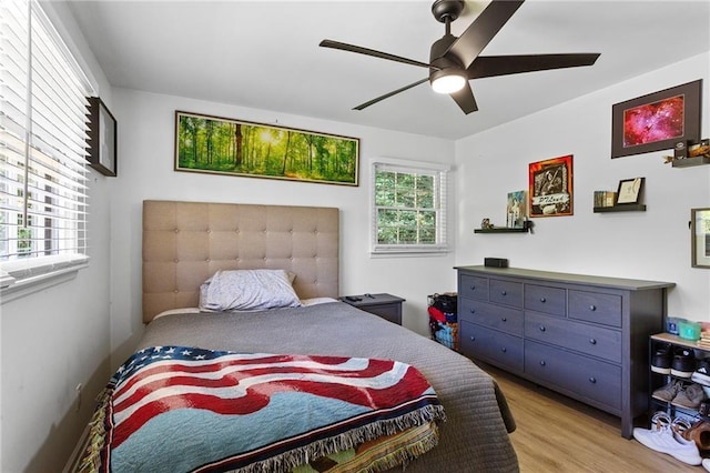 bedroom with a ceiling fan and light wood-style flooring