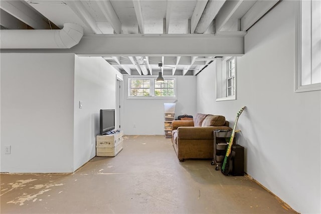 living area featuring unfinished concrete floors