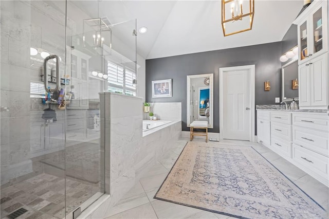 bathroom with marble finish floor, lofted ceiling, a stall shower, vanity, and a bath