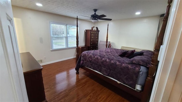 bedroom featuring recessed lighting, visible vents, dark wood-type flooring, a textured ceiling, and baseboards