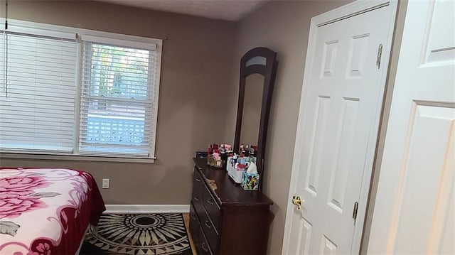 tiled bedroom featuring baseboards