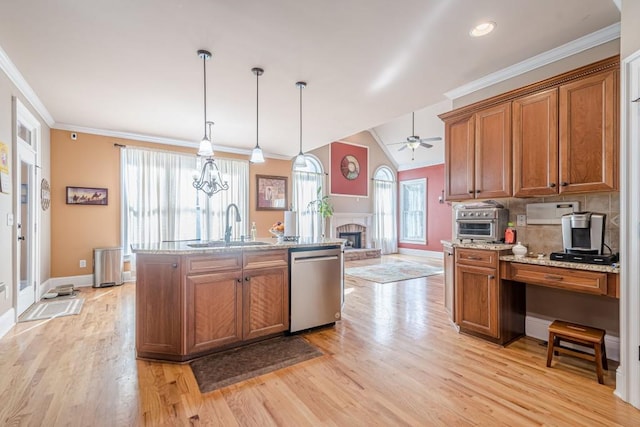 1765 Dew Pl, Marietta, GA 30064 - kitchen with stainless steel dishwasher, a sink, brown cabinets, baseboards, and light wood-style floors