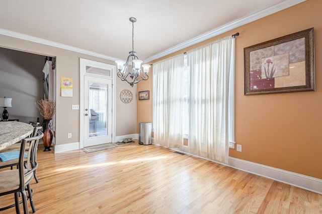 1765 Dew Pl, Marietta, GA 30064 - dining area with a chandelier, light wood-style flooring, ornamental molding, and baseboards