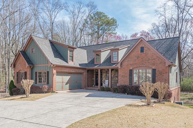 1765 Dew Pl, Marietta, GA 30064 - view of front facade featuring a porch, board and batten siding, driveway, and brick siding