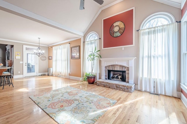 1765 Dew Pl, Marietta, GA 30064 - unfurnished living room featuring wood finished floors, vaulted ceiling, ceiling fan, a fireplace with raised hearth, and a chandelier