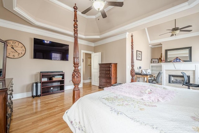 1765 Dew Pl, Marietta, GA 30064 - bedroom featuring a tray ceiling, light wood finished floors, a fireplace, crown molding, and ceiling fan