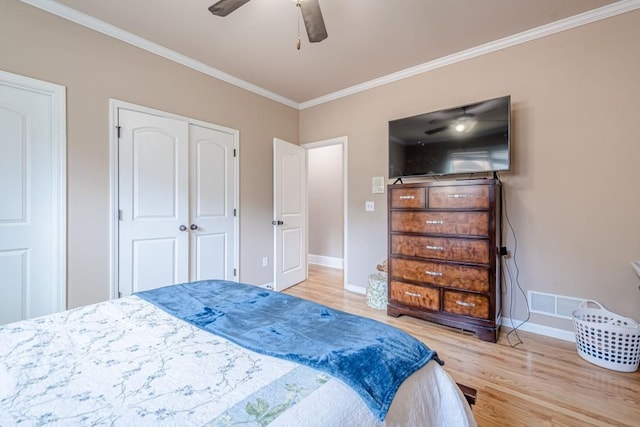 1765 Dew Pl, Marietta, GA 30064 - bedroom featuring crown molding, wood finished floors, baseboards, ceiling fan, and a closet
