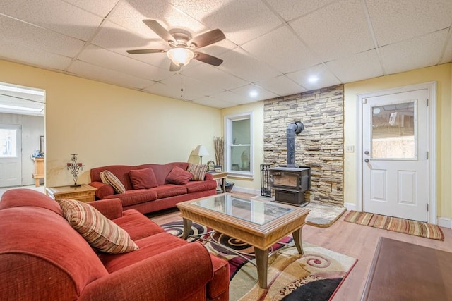 1765 Dew Pl, Marietta, GA 30064 - living area featuring a wood stove, a paneled ceiling, wood finished floors, and a ceiling fan