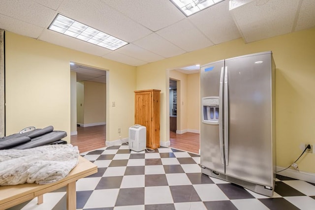 1765 Dew Pl, Marietta, GA 30064 - kitchen featuring stainless steel refrigerator with ice dispenser, dark flooring, a drop ceiling, and baseboards