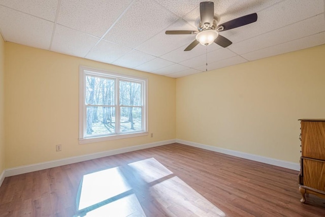 1765 Dew Pl, Marietta, GA 30064 - empty room with wood finished floors, baseboards, ceiling fan, and a paneled ceiling