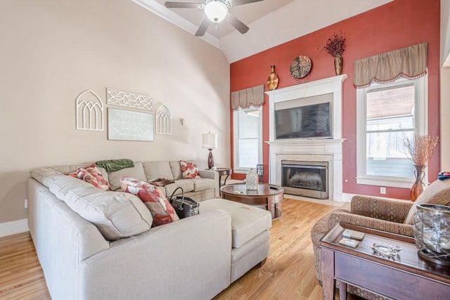 1765 Dew Pl, Marietta, GA 30064 - living room featuring ceiling fan, light wood-style floors, vaulted ceiling, a fireplace with flush hearth, and baseboards