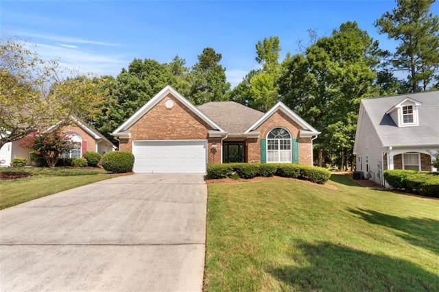 view of front of home with brick siding, driveway, a front yard, and an attached garage