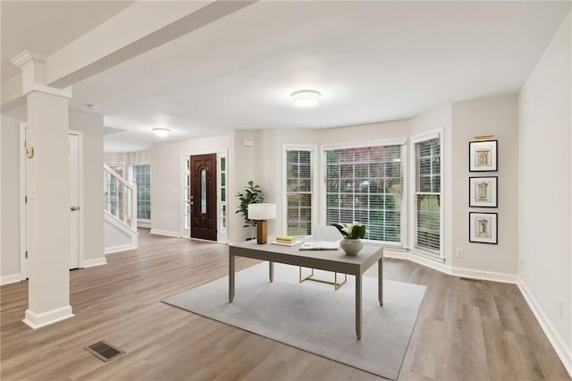 living area with beam ceiling and dark hardwood / wood-style flooring