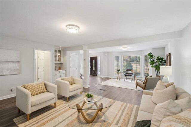 living room featuring dark wood-type flooring and a high end fireplace