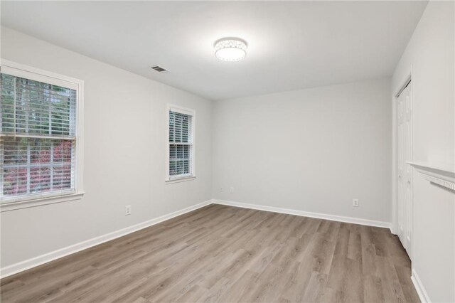 empty room with light hardwood / wood-style flooring