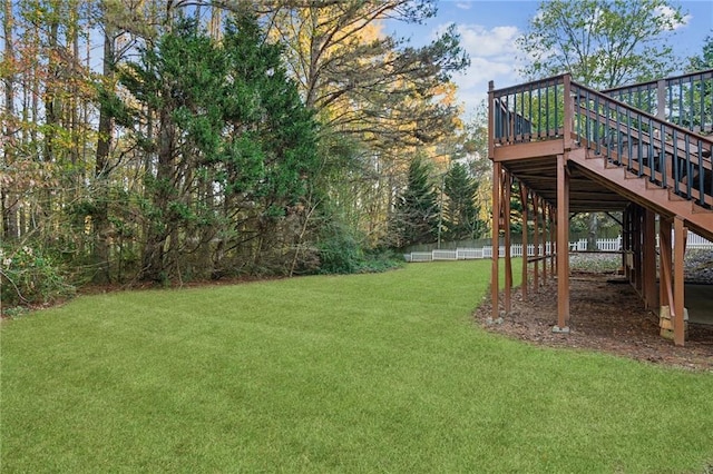 back of house with a lawn and a deck