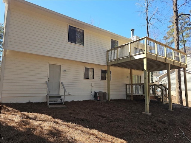 back of property featuring central air condition unit, entry steps, and a wooden deck