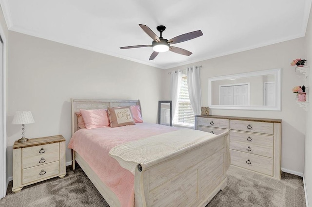 bedroom with light colored carpet, baseboards, ornamental molding, and a ceiling fan