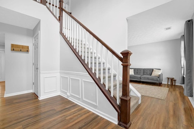 stairway with wood finished floors