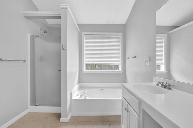 full bathroom with a stall shower, tile patterned floors, vanity, and healthy amount of natural light