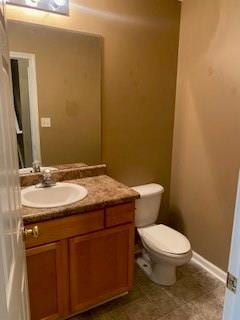 bathroom with tile patterned floors, vanity, and toilet