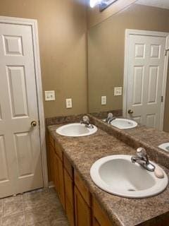 bathroom featuring tile patterned flooring and vanity