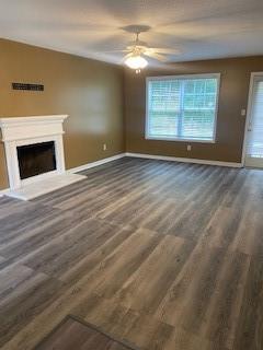 unfurnished living room with ceiling fan and hardwood / wood-style flooring