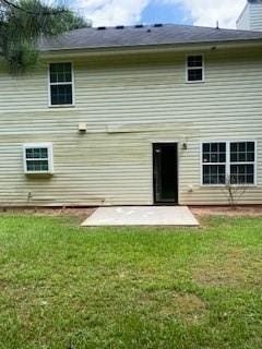 back of house with a patio area and a yard