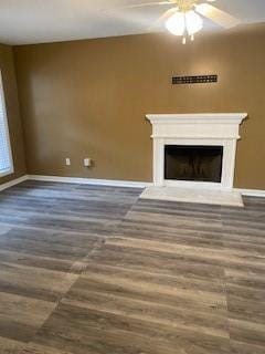 unfurnished living room featuring ceiling fan and hardwood / wood-style floors