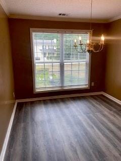 unfurnished dining area with hardwood / wood-style flooring, a notable chandelier, and ornamental molding