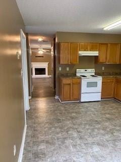 kitchen featuring tile patterned floors, white range with electric stovetop, and ceiling fan