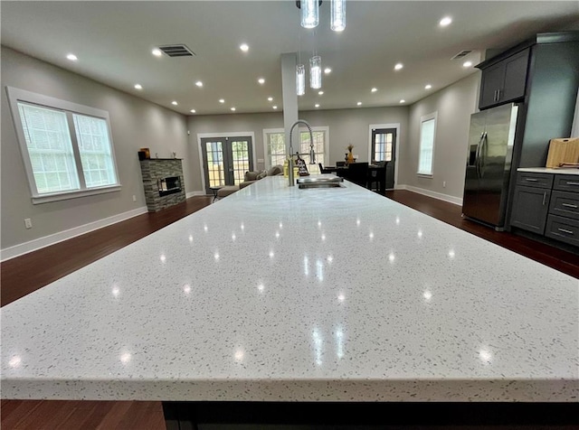 1255 Plaza Ave SW, Atlanta, GA 30310 - kitchen featuring stainless steel refrigerator with ice dispenser, a large island with sink, open floor plan, dark wood-style flooring, and recessed lighting
