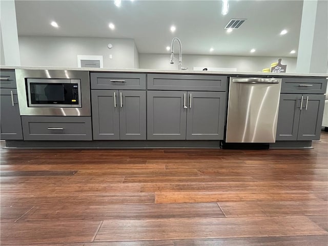 1255 Plaza Ave SW, Atlanta, GA 30310 - kitchen with appliances with stainless steel finishes, gray cabinets, a sink, dark wood-type flooring, and light countertops