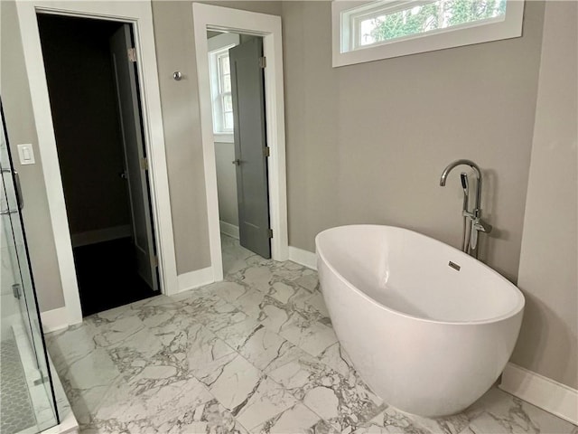 1255 Plaza Ave SW, Atlanta, GA 30310 - full bathroom with marble look tile flooring, baseboards, a soaking tub, and a shower stall