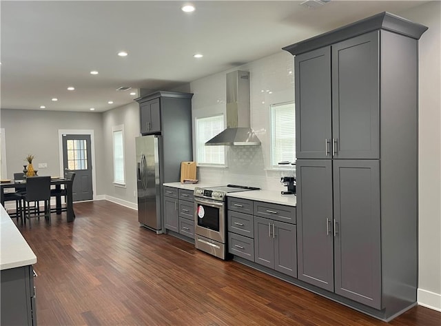 1255 Plaza Ave SW, Atlanta, GA 30310 - kitchen featuring wall chimney exhaust hood, appliances with stainless steel finishes, gray cabinetry, light countertops, and dark wood finished floors