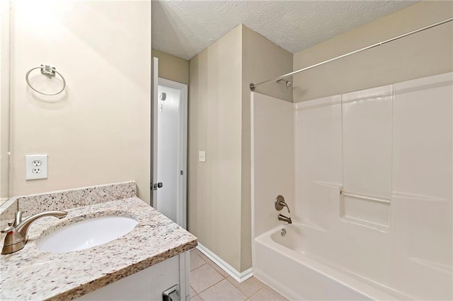 bathroom featuring shower / bathtub combination, a textured ceiling, vanity, tile patterned flooring, and baseboards