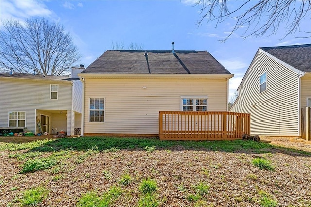 rear view of property featuring a wooden deck